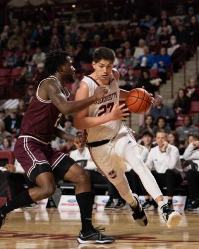 Josh Cohen (23) drives baseline on a Fordham defender during the first half of UMass’ 66-64 win over the Rams on Wednesday night at the Mullins Center.