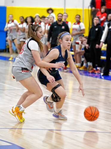 Northampton’s Bri Heafey (5) dribbles the ball against Worcester South defender Nicole Jodian (30) in the third quarter of the MIAA Div. 2 girls basketball state semifinals Tuesday night at Chicopee Comp High School.