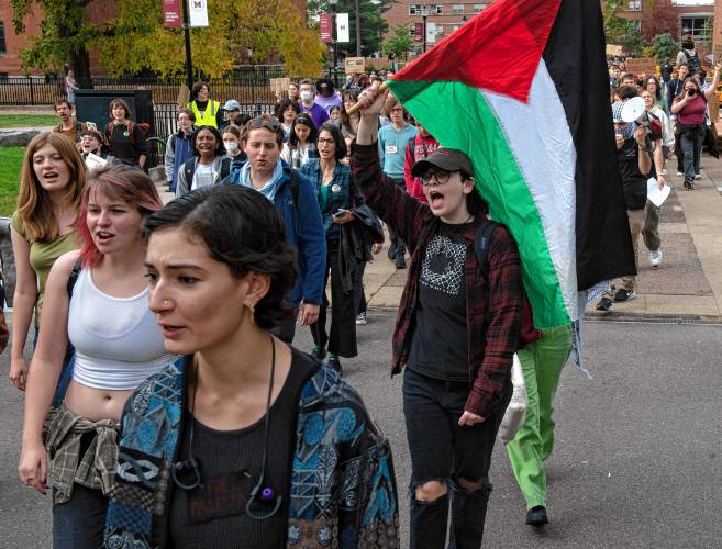 Around 300 UMass students walk to the chancellor's office in Whitmore during a walkout and sit-in event on Wednesday to demand that the university cut ties with weapons manufacturers and condemn Israeli actions in Gaza.