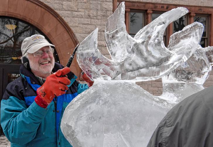  David Barclay works on an ice sculpture in front of Forbes Library as part of the Northampton Winter festival happening Saturday, Jan. 20, 2024. 