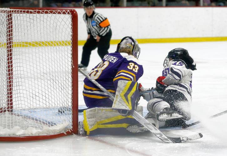 Amherst College’s Alyssa Xu (15) wraps a shot around Elmira College goalie Chloe Beaubien (33) that missed just wide of the net in the third period of the NCAA quarterfinals Saturday afternoon at Orr Rink.