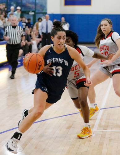 Northampton’s Ava Azzaro (13) drives the ball past Worcester South defender Naima Bleou (5) in the second quarter of the MIAA Div. 2 girls basketball state semifinals Tuesday night at Chicopee Comp High School.
