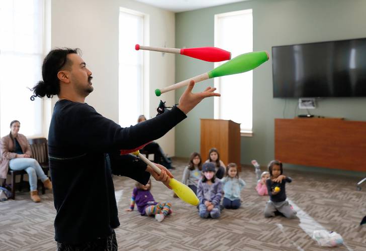 Joseph Goldin demonstrates juggling techniques using pins during a learn to juggle event Tuesday afternoon at the Hadley Public Library.