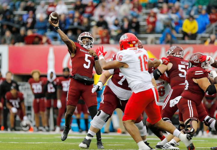 Umass quarterback Carlos Davis (5) throws a 24-yard pass to wide receiver Christian Wells for a touchdown against New Mexico in the second quarter Saturday at McGuirk Alumni Stadium in Amherst.