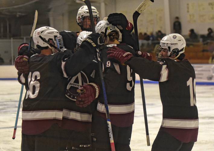 Amherst players celebrate a second-period goal by Skyler Ferro (2) during the visiting Hurricanes’ 3-1 victory over Greenfield on Monday at Collins-Moylan Arena in Greenfield.