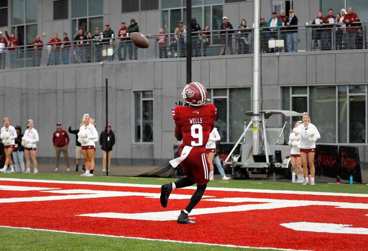 Umass wide receiver Christian Wells (9) reels in an over-the-shoulder pass from quarterback Carlos Davis for 24-yard touchdown against New Mexico in the second quarter Saturday at McGuirk Alumni Stadium in Amherst.