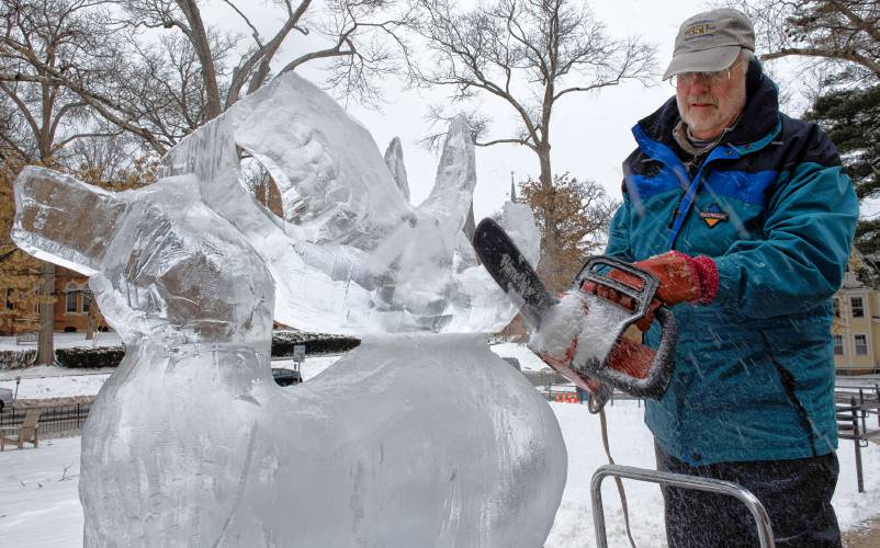  Barclay employs a chain saw as he works on an ice sculpture in front of Forbes Library in preparation for Winterfest. 
