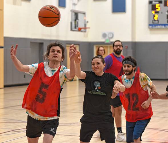 Collee Williams, left, and Allen Riccio, far right, of the Fireballers try to corral a loose ball with Cathy Potak, center, of the Fighting Artichokes, also in pursuit during the championship game of the inaugural Division Q season earlier this month at Mountain View School in Easthampton.