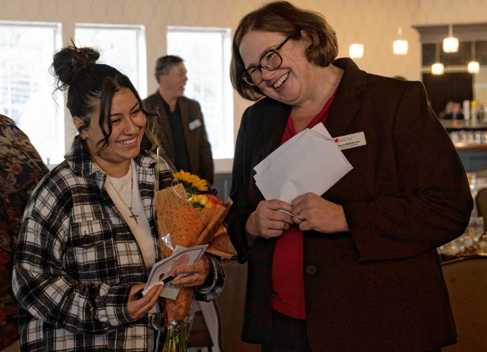 Jenny Saravia, the keynote speaker at the Children's Advocacy Center of Hampshire County breakfast, talks with Kara McElhone, the center’s executive director, at the end of the event on Friday morning.