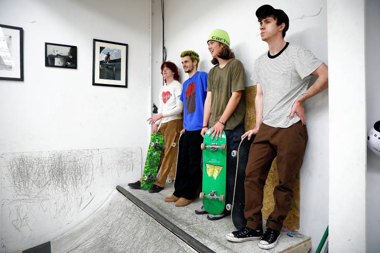 Skaters Jamie Payne, from left, Liam Stapleton, Tanner Kelting and Kegan O’Keefe wait on deck at the recently opened Easthampton Skate Club at Eastworks.