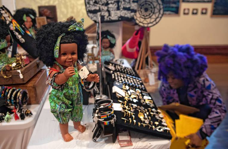 Small dolls of Black girls for sale are posed around Aimee Salmon’s new store, Positively Africana , which she hopes will expose kids to diverse cultures early on.