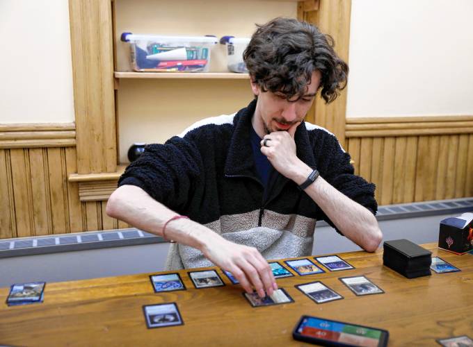 James Echols instructs a game of Magic: the Gathering on Thursday night at Lilly Library in Florence.