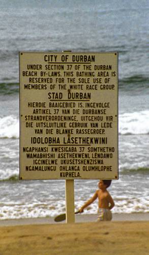 A sign from South Africa during the apartheid era that announces in English, Afrikaans and Zulu that a beach area is reserved for whites only.