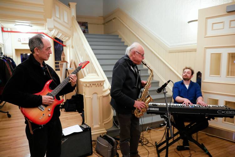 The Crimson Canary Jazz Trio performs in the City Space lobby Thursday night for attendees of the Easthampton City Arts monthly Art Walk event. From left are Dave Chu, Richard Murphy and Dylan Walter.