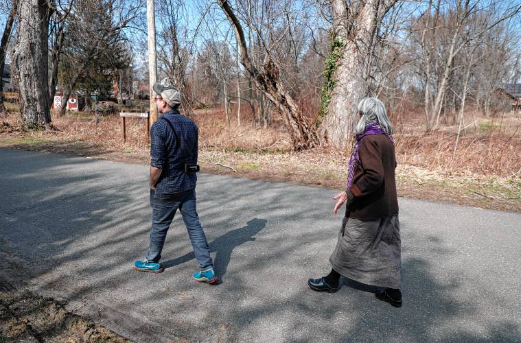 Ben James and Claudia Lefko walk through the Montview neighborhood along with Gail Hornstein, out of frame.