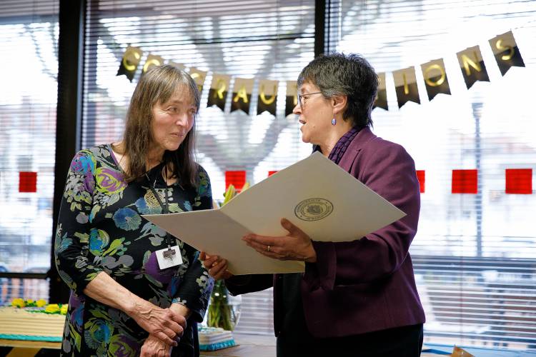 State Rep. Mindy Domb, right, presents Helen MacMellon with a citation from the House of Representatives during last Friday’s retirement party. 
