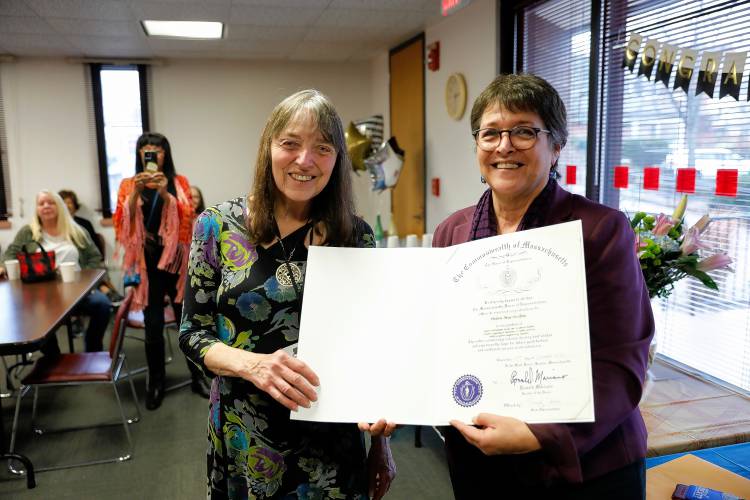 State Rep. Mindy Domb, D-Amherst, right, presents Helen MacMellon with a citation from the House of Representatives during her retirement party lastFriday at the Bangs Community Center in Amherst.