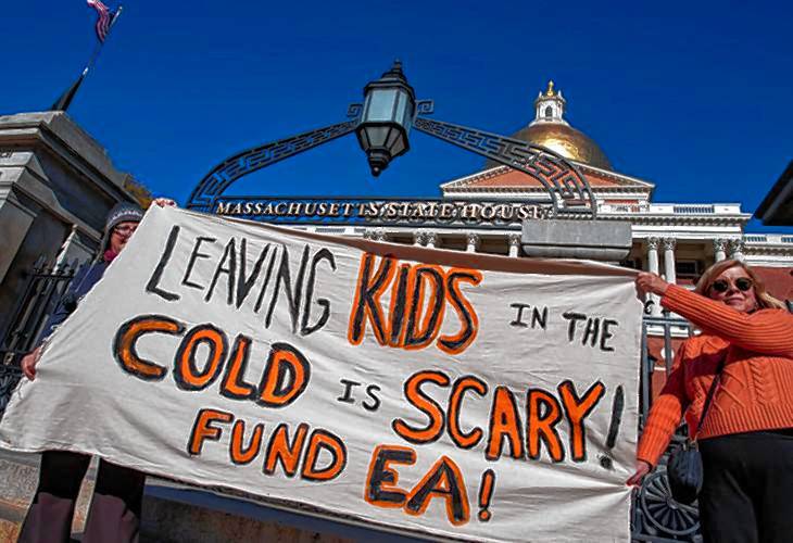 Advocates rally on the State House steps on Tuesday calling for the state to abide by its right to shelter law for migrant families and for lawmakers to approve additional money for the emergency shelter system.