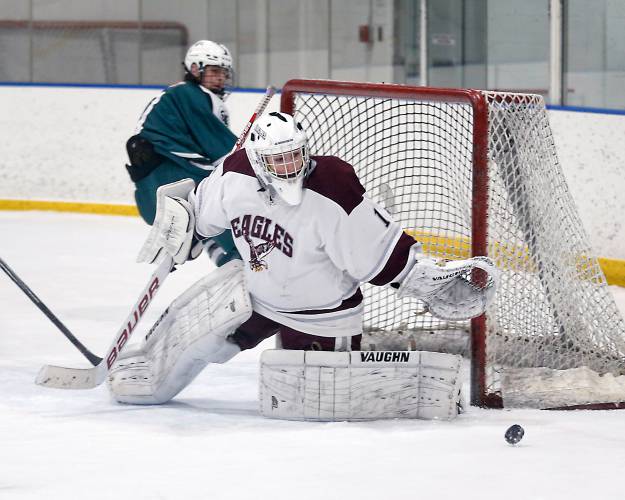Easthampton goalkeeper Paige Galpin deflects a shot from Greenfield last season at Lossone Rink in Easthampton.