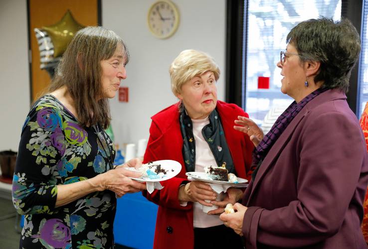 Helen MacMellon, left, who is retiring from her time as a social worker and program director at the Amherst Council on Aging, talks with Phyllis Lehrer and state Rep. Mindy Domb during her retirement party Friday at the Bangs Community Center in Amherst.