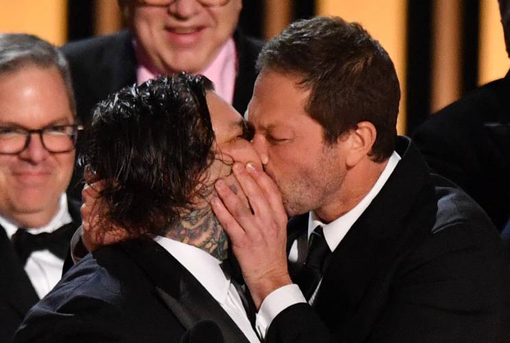 Actor Ebon Moss-Bachrach, right, a native of Amherst, kisses chef and actor Matty Matheson as the cast and crew of “The Bear” accept the award for outstanding comedy series onstage during the 75th Emmy Awards at the Peacock Theatre at L.A. Live in Los Angeles on Monday.