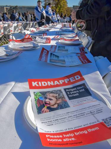 Flyers that were attached to plates during a community event titled “Bring Them Home,” sponsored by UMass Hillel. Each plate was taped to tables in a symbolic ritual of Shabbat honoring the 240 hostages kidnapped from Israel by Hamas.