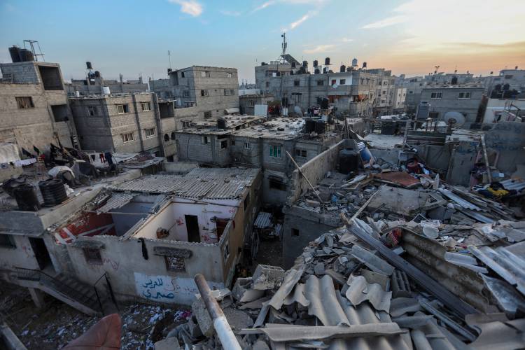 Palestinian citizens inspect the destruction caused by air strikes on their homes on Sunday, Dec. 3, 2023, in Khan Yunis, Gaza. (Ahmad Hasaballah/Getty Images/TNS)