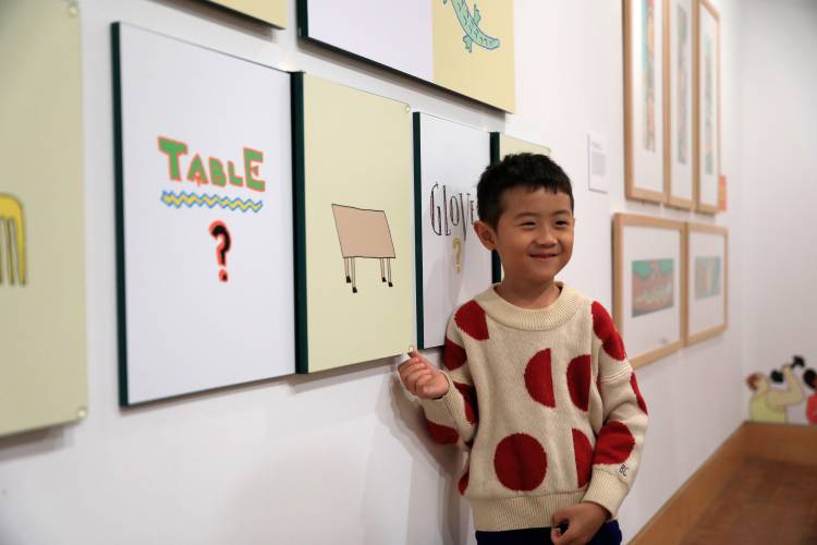 Camera-ready: Siun Kim, 6, checks out an interactive element of a new exhibit, “Kid in a Candy Store,” at the Eric Carle Museum.