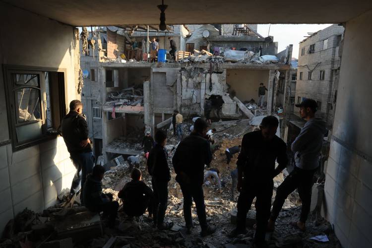 Palestinians inspect the destruction around residential buildings following Israeli air strikes in the Rafah refugee camp in the southern Gaza Strip on Dec. 1, 2023, as fighting resumed shortly after the expiration of a seven-day truce between Israel and Hamas militants.