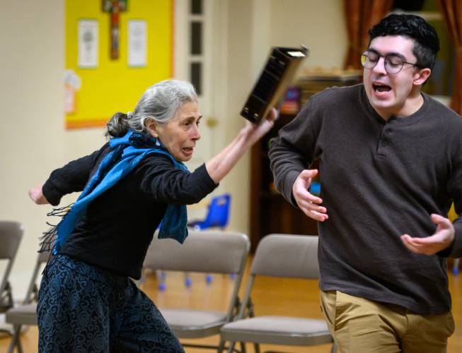 “Take that!” Rona Leventhal, left, and Devin Dumas of Easthampton Theater Company rehearse “Torch Song” at the parish hall of St. Philip’s Episcopal Church in Easthampton.