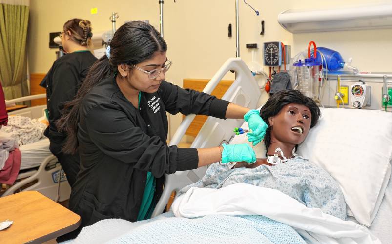 A nursing student works on a “patient” during a training exercise at the college’s Center for Health Education & Simulation. 