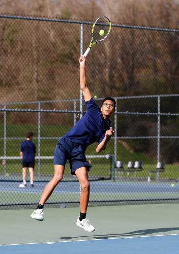 Northampton’s Durrell Patrick serves against Amherst’s Elias Katsaros during their No. 2 singles match Wednesday in Amherst.